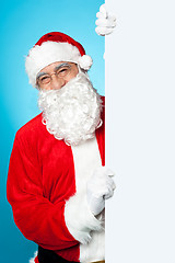 Image showing Santa posing beside long blank banner ad