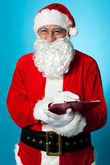 Image showing Santa Claus making his list of the good children