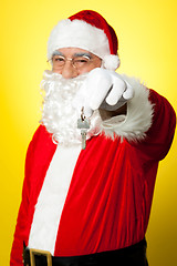 Image showing Aged Santa dangling a key