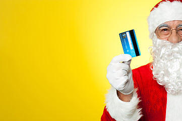 Image showing Cropped image of aged Santa holding credit card