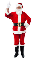 Image showing Bespectacled Santa pointing upwards