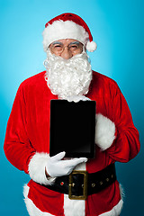 Image showing Father Christmas presenting a new tablet device