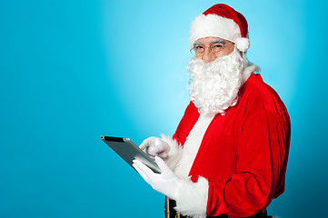 Image showing Santa using newly launched electronic tablet device