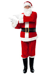 Image showing Man in Santa costume indicating at copy space area