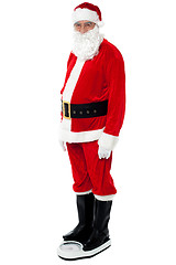 Image showing Health conscious Santa checking his weight