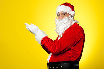 Image showing Side profile of Santa facing camera with open palms