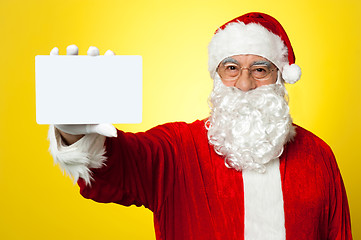 Image showing Saint Nick flashing a blank placard to the camera