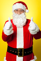 Image showing Cheerful male in Santa costume showing double thumbs up