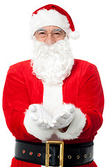 Image showing Bespectacled Father Santa posing with open palms