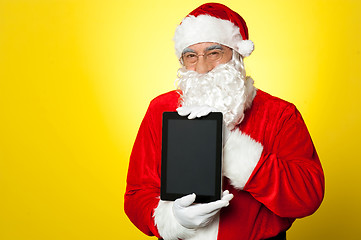 Image showing Santa Claus holding newly launched tablet device