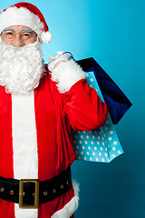 Image showing Saint Nicholas carrying colorful shopping bags