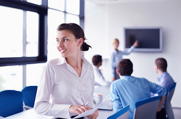 Image showing business woman with her staff in background at office