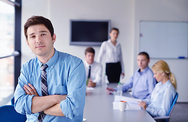 Image showing business man  on a meeting in offce with colleagues in backgroun