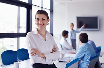 Image showing business woman with her staff in background at office