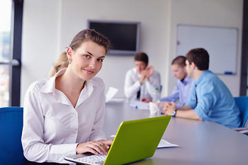 Image showing business woman with her staff in background at office