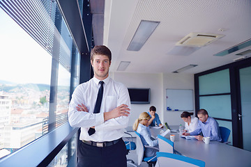 Image showing business man  on a meeting in offce with colleagues in backgroun