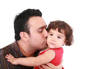 Image showing Father hugging and kissing little daughter, smiling. 