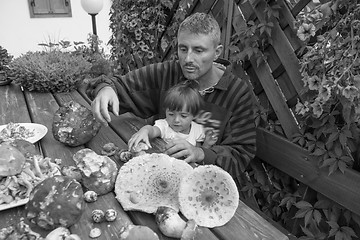 Image showing Father and Daughter happy with a table full of Boletus Mushrooms