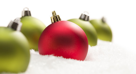 Image showing Red and Green Christmas Ornaments on Snow Flakes on White