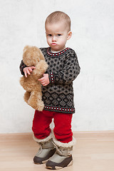 Image showing Baby in winter clothes with toy