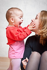 Image showing Mother playing with baby daughter