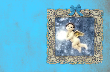 Image showing christmas vintage cards, angel in an old painting on blue wall