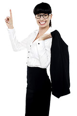 Image showing Lively female entrepreneur pointing upwards