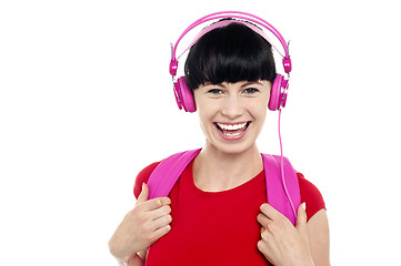 Image showing Young girl listening to music, using headphones