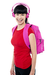 Image showing Student enjoying music on her way to college