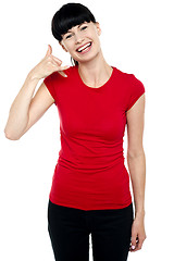 Image showing Cheerful brunette gesturing a mock call