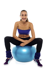 Image showing Fitness woman relaxing on exercise ball
