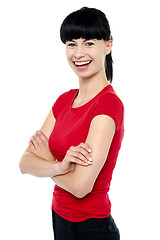 Image showing Pretty slim lady in bright red top, arms folded