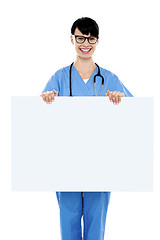 Image showing Medical practitioner holding blank ad board