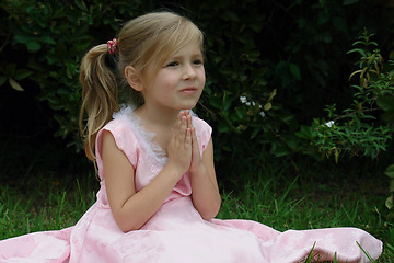Image showing Praying girl on the grass