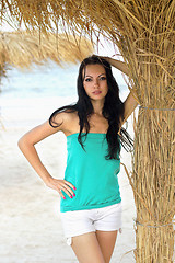 Image showing  woman on beach near the palm tree