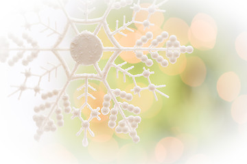 Image showing Snowflake Over an Abstract Green and Gold Background