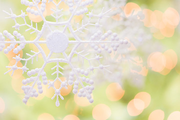 Image showing Snowflake Over an Abstract Green and Gold Background