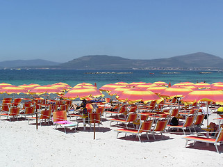 Image showing Summer beach - red parasols