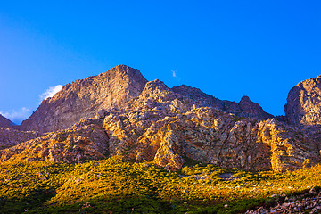 Image showing Orange-lit cliffs and blue sky