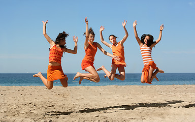 Image showing Four girls jumping