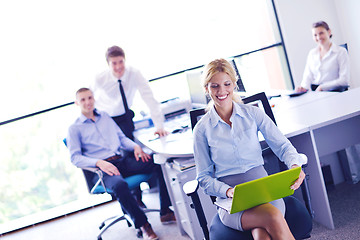 Image showing business woman with her staff in background at office