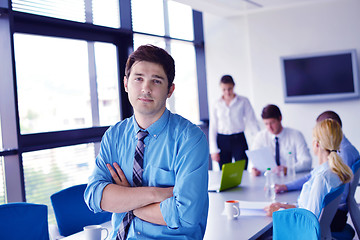 Image showing business man  on a meeting in offce with colleagues in backgroun