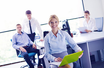 Image showing business woman with her staff in background at office