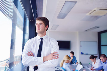 Image showing business man  on a meeting in offce with colleagues in backgroun