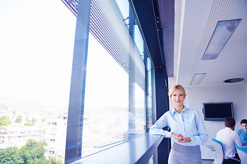 Image showing business woman with her staff in background at office