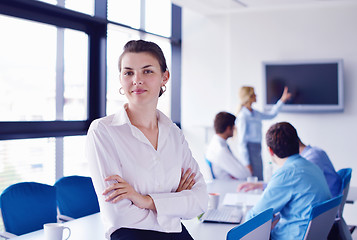 Image showing business woman with her staff in background at office