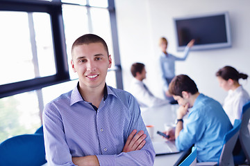 Image showing business man  on a meeting in offce with colleagues in backgroun