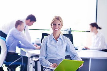 Image showing business woman with her staff in background at office