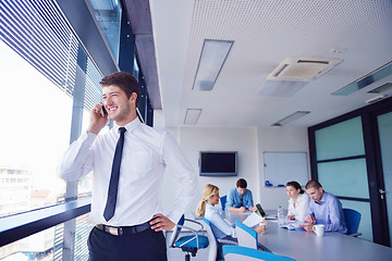 Image showing business man  on a meeting in offce with colleagues in backgroun