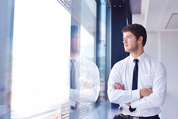 Image showing business man  on a meeting in offce with colleagues in backgroun